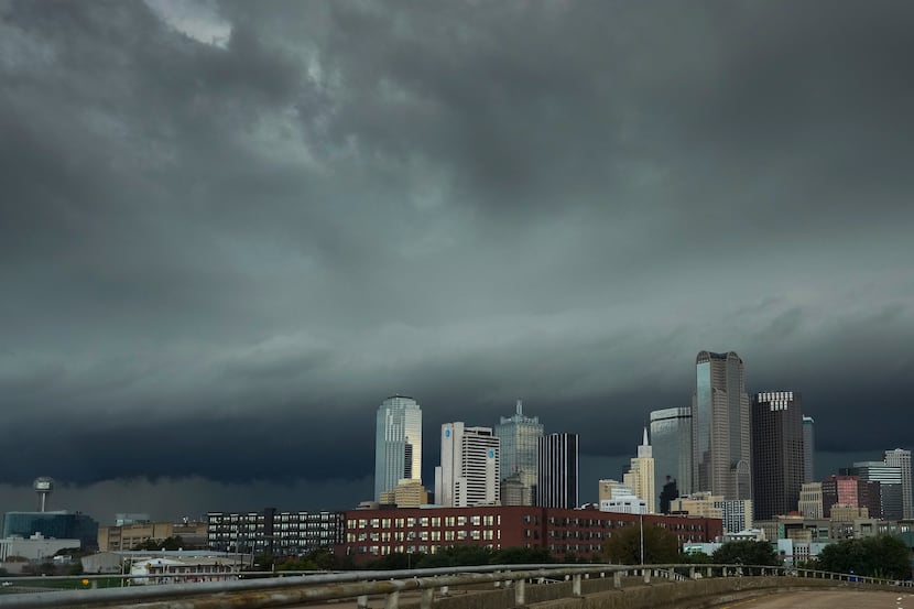 Storm clouds roll over the downtown skyline as severe storms move through North Texas on...