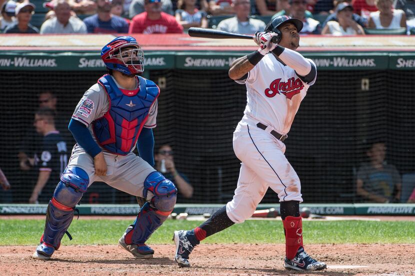 Cleveland Indians' Jose Ramirez watches his two-run home run off Texas Rangers starting...
