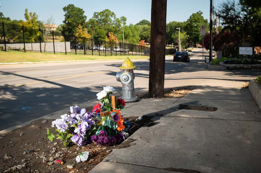 A flower memorial for Joseph Syas sits on Eastridge Drive on Aug. 11. A police camera down...