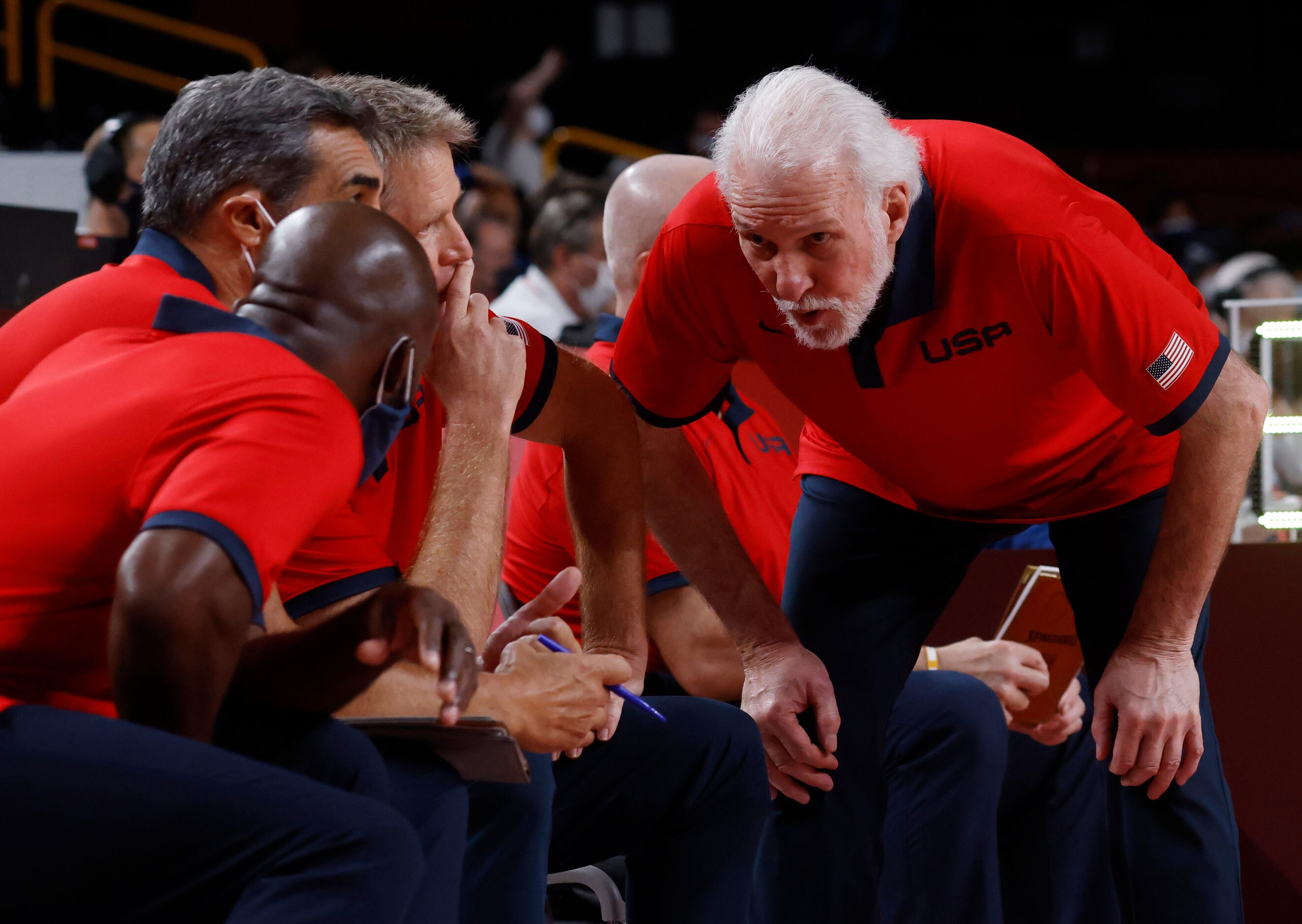 USA’s head coach Gregg Popovich (right) talks to assistant Lloyd Daniel Pierce (left) and...