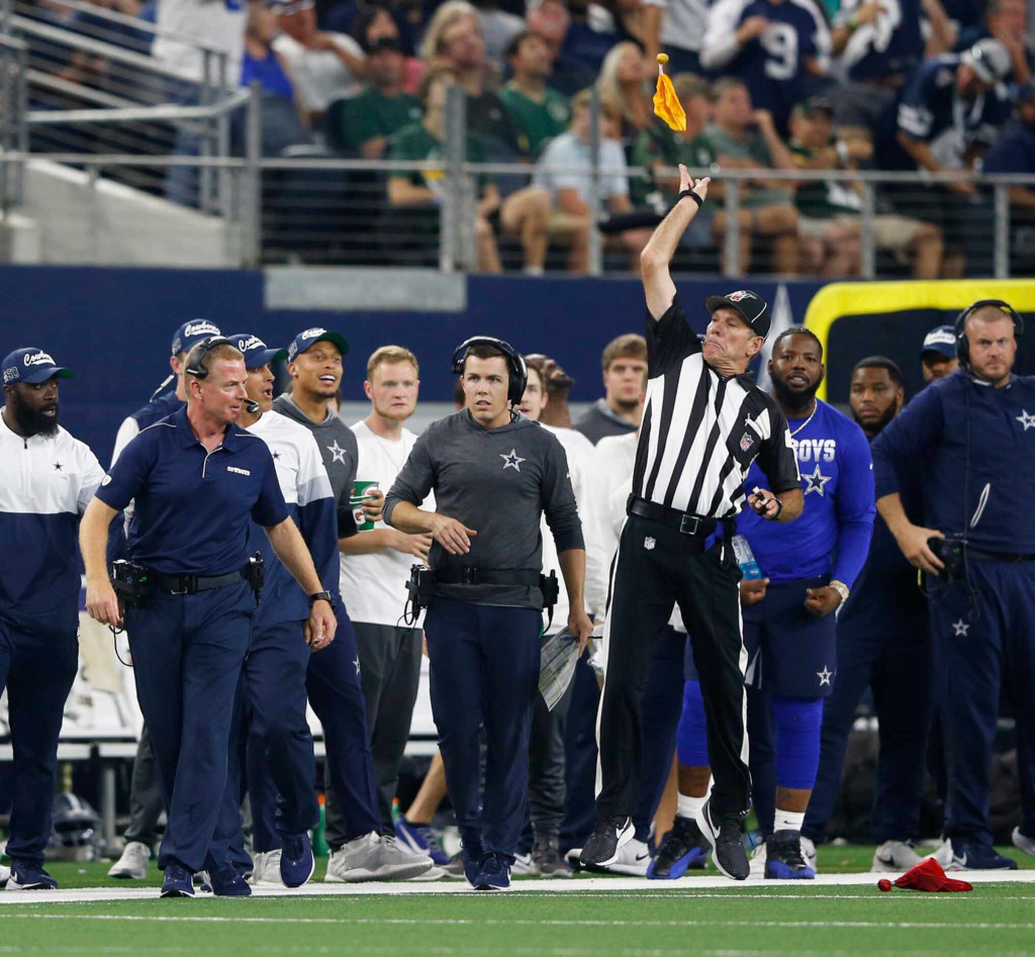Side judge Scott Edwards (3) throws a penalty flag after Dallas Cowboys head coach Jason...