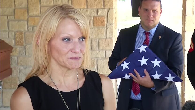 Tiffany McCullers talks to reporters at the burial for her husband, SMU Officer Mark...