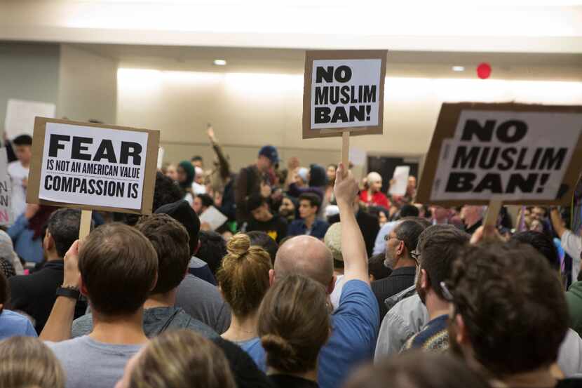 Protesters gather to denounce President Donald Trump's executive order that bans certain...