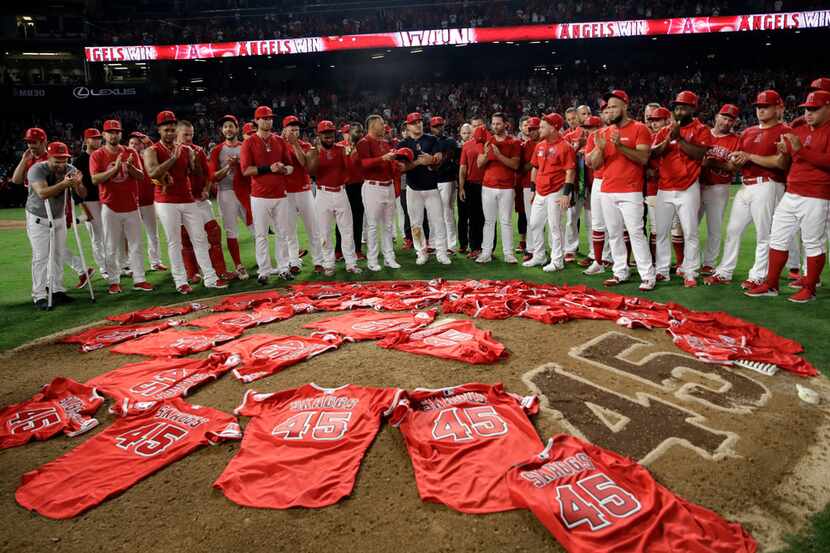 Members of the Los Angeles Angels place their jerseys with No. 45 in honor of pitcher Tyler...