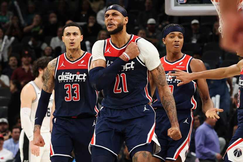 Washington Wizards center Daniel Gafford (21) reacts beside forward Kyle Kuzma (33) and...