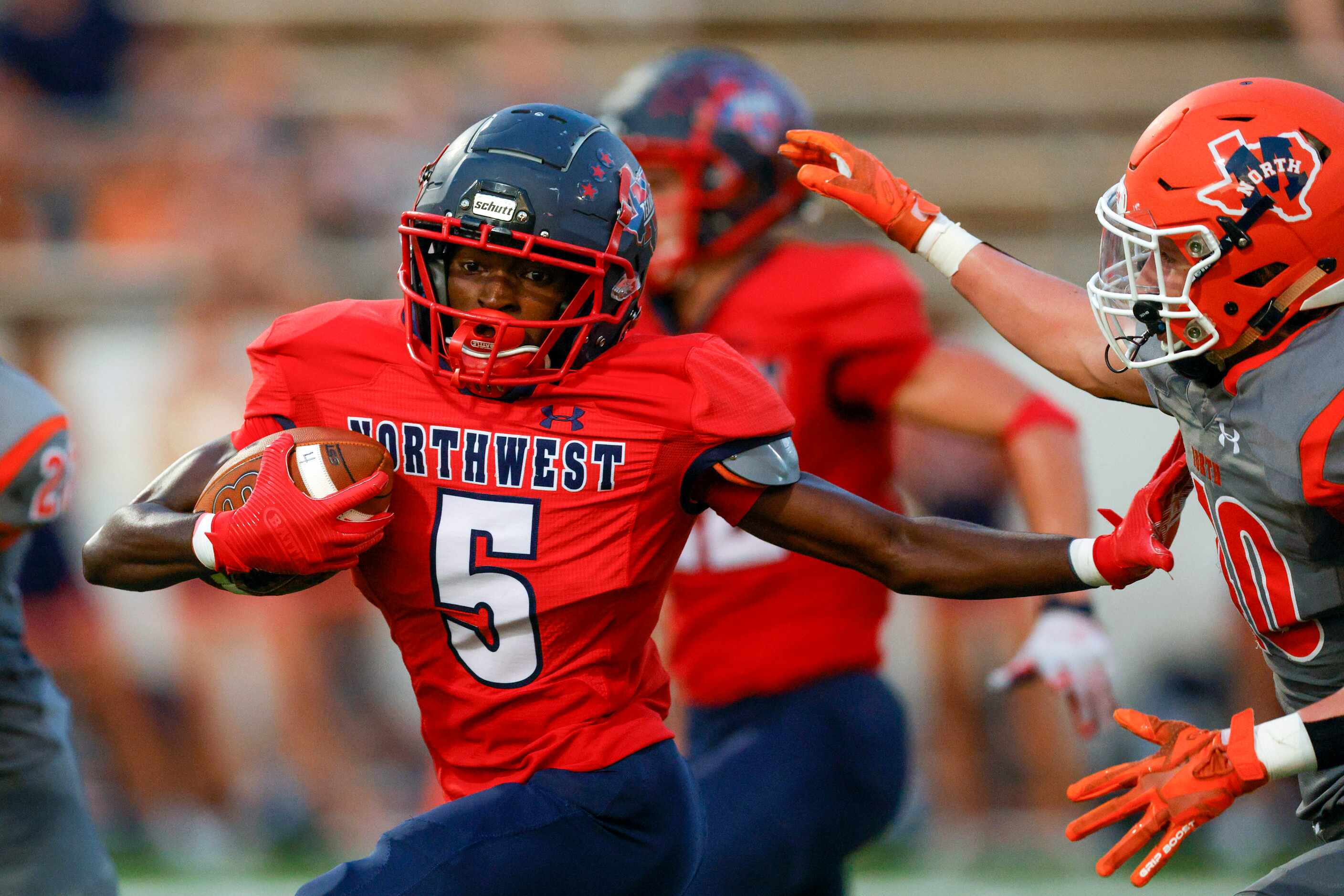 Justin Northwest wide receiver Terry Duncan (5) stiff-arms McKinney North safety Jackson...