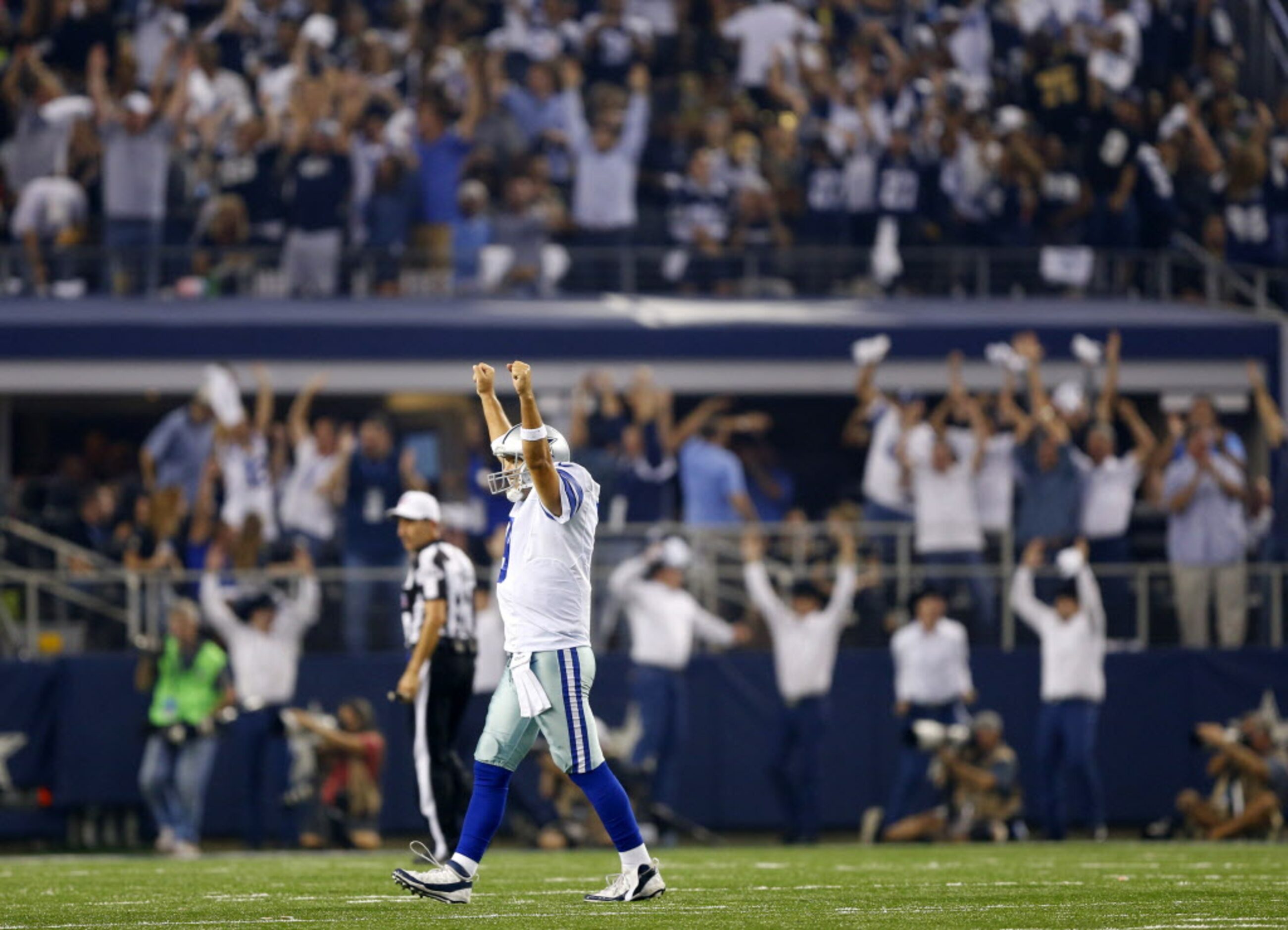 Dallas Cowboys quarterback Tony Romo (9) raises his arms after running back DeMarco Murray...