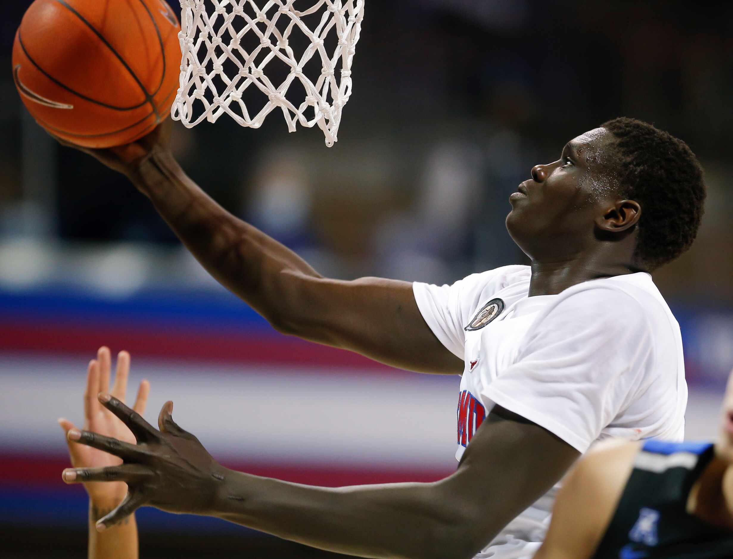 SMU forward Yor Anei (10) attempts a layup during the second half of a college basketball...