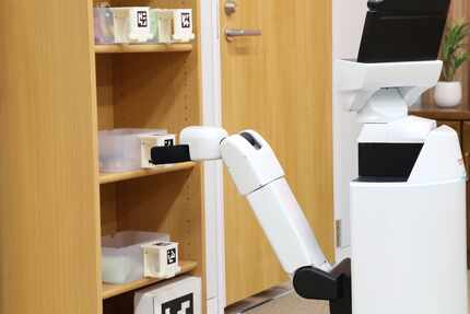 A Toyota human support robot can do simple tasks like tidying up or delivering meals.