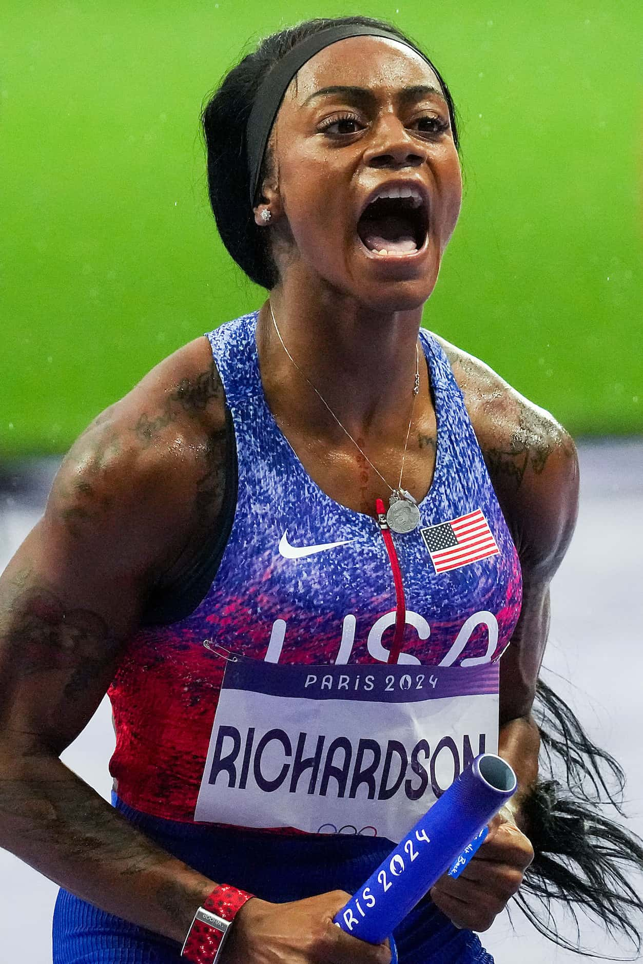 Sha'carri Richardson of the United States celebrates after crossing the finish line to win...