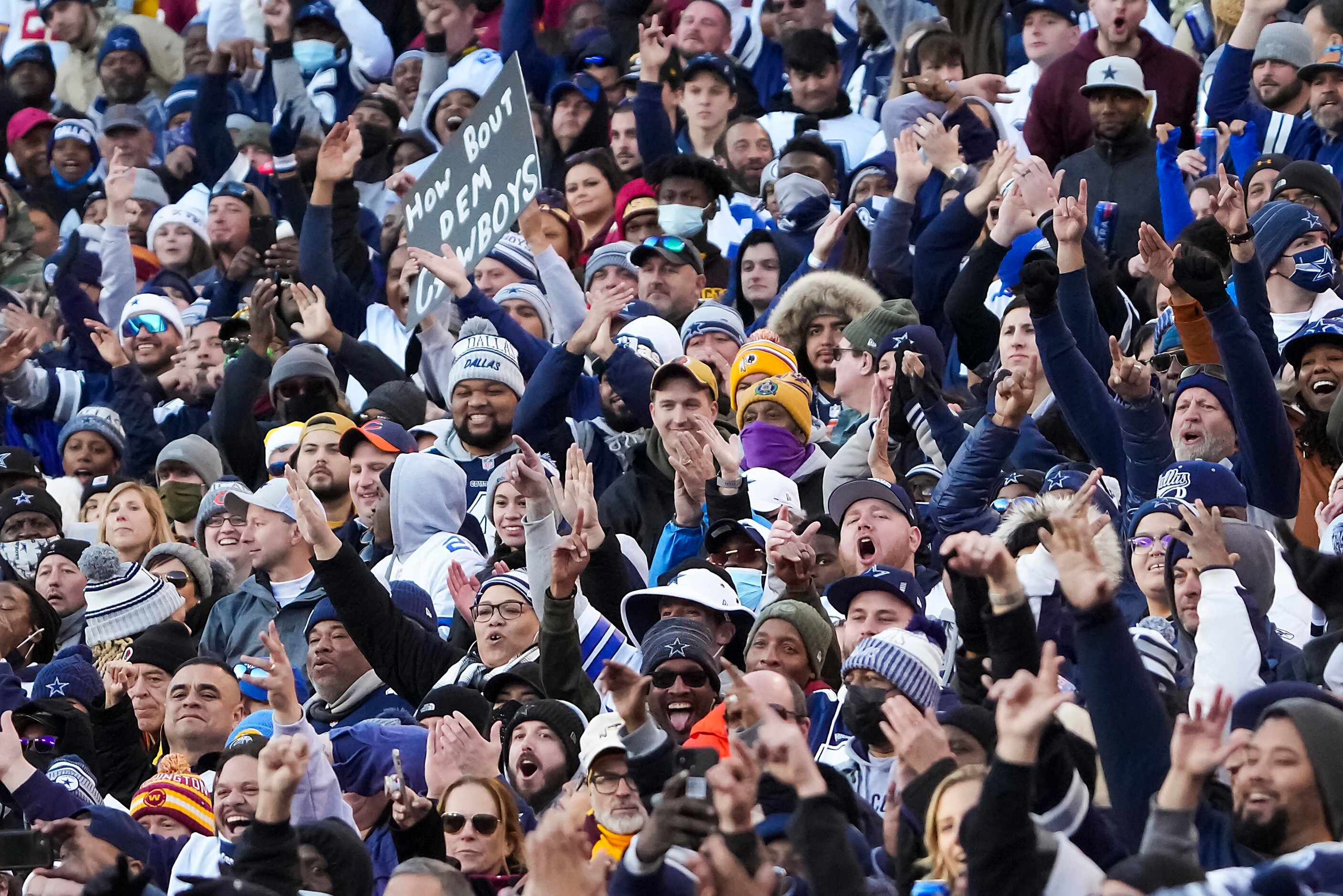 Dallas Cowboys fans celebrate during the second half of an NFL football game against the...