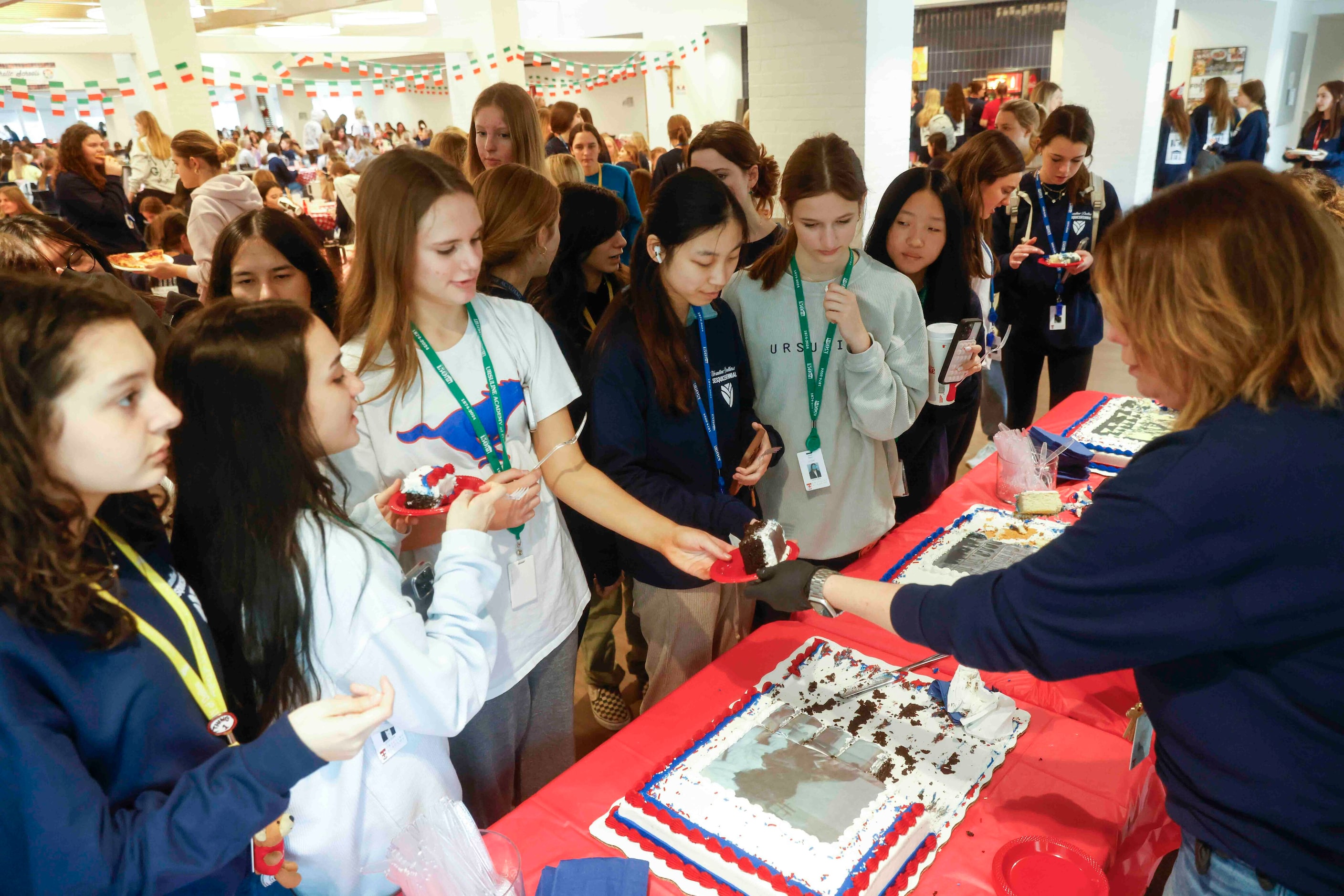 Students receive celebratory cake during the 150th anniversary celebration of Ursuline...