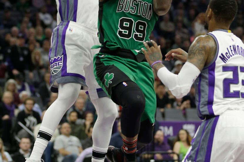Boston Celtics forward Jae Crowder, right, goes to the basket against Sacramento Kings...