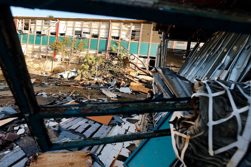 A tree was slammed against Cary Middle School in Dallas by a tornado, Monday, October 21,...