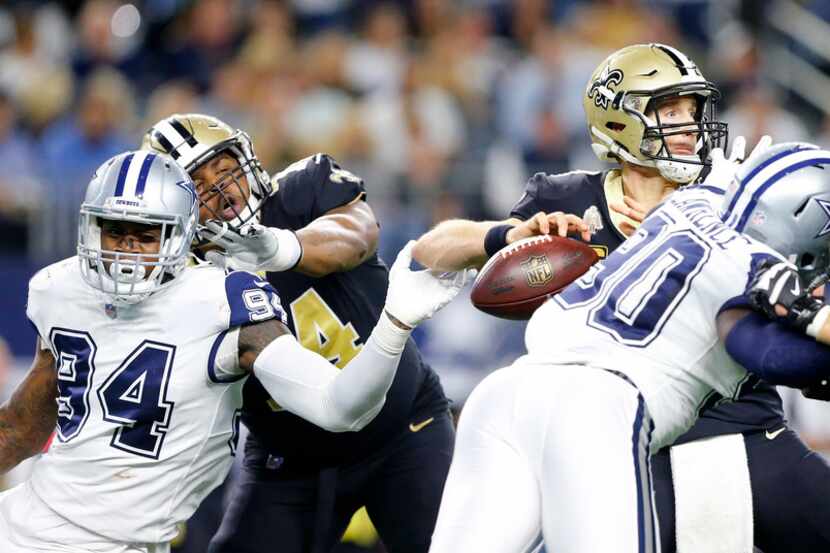 New Orleans Saints quarterback Drew Brees (9) has the ball locked from his hand by Dallas...