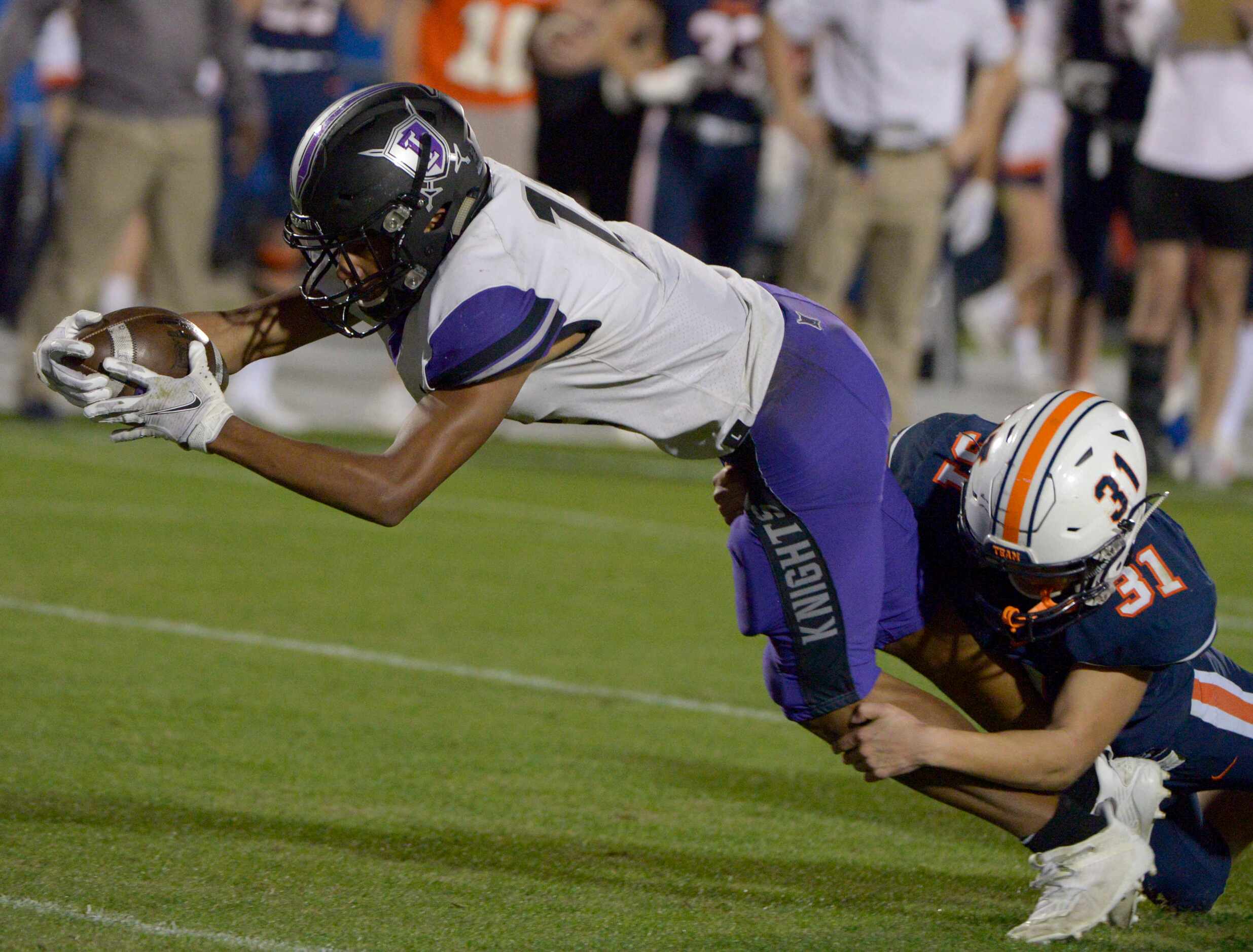 Frisco Independence Reggie Bush (12) reaches for a touchdown as he’s tackled by Wakeland’s...