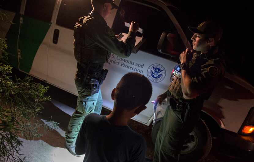 Border Patrol agents Edgar Cano (right) and Richard Schweitzer processed unaccompanied minor...
