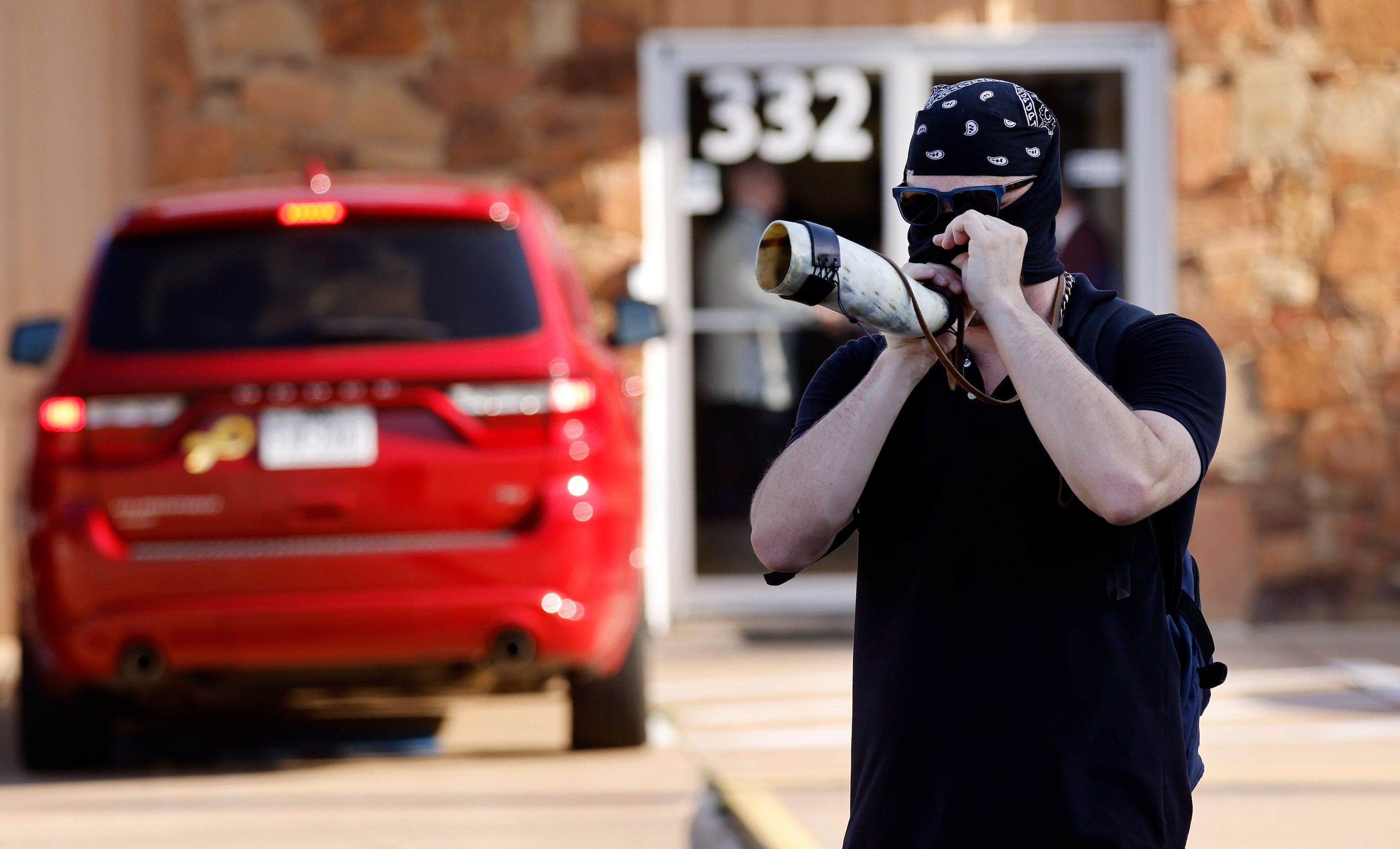 A protestor with No Hate In Texas uses a real bullhorn to annoy New Independent...