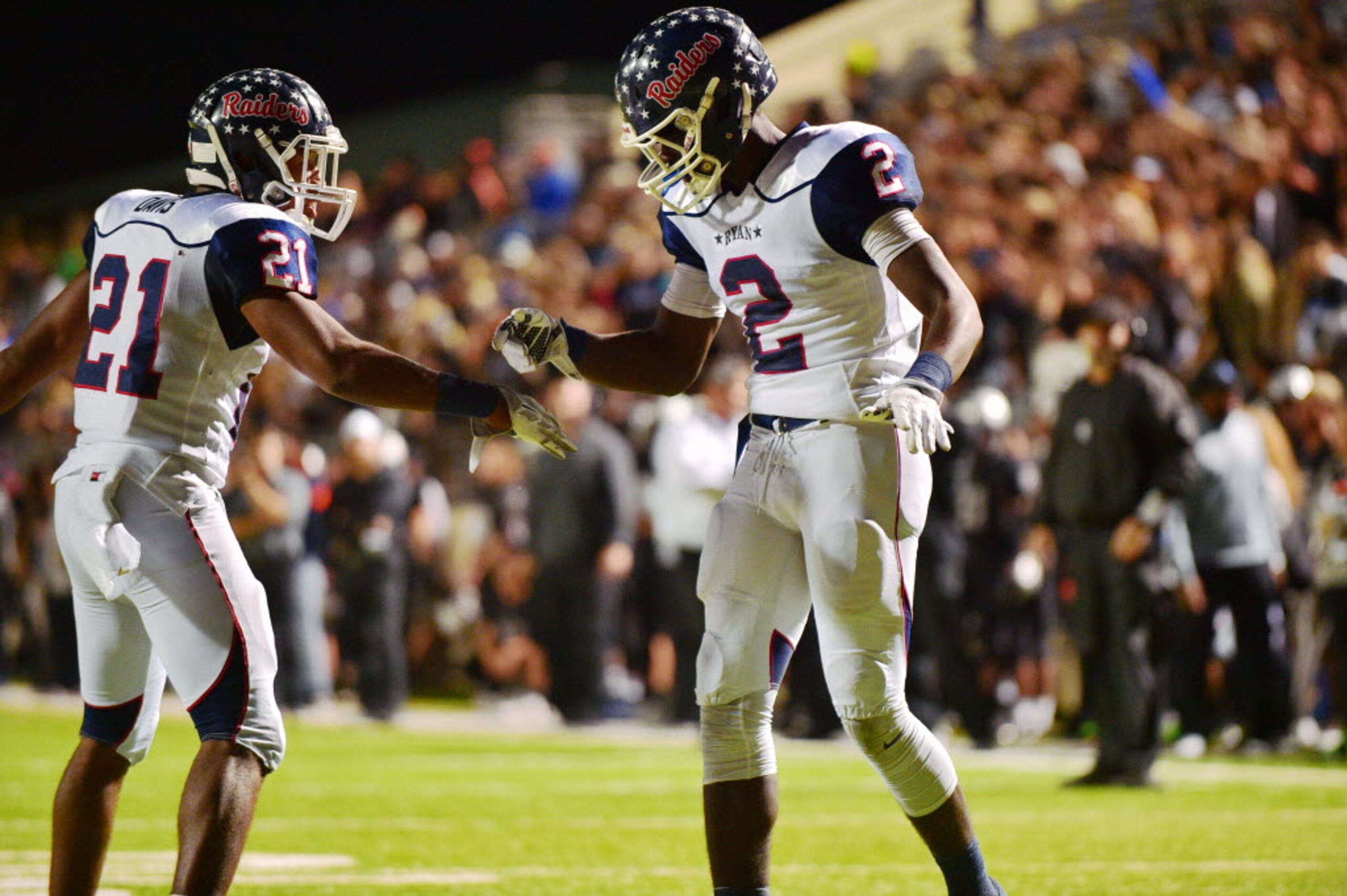 Ryan junior running back Tyreke Davis (21) and sophomore wide receiver Gabriel Douglas (2)...