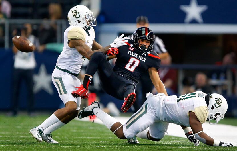 Texas Tech Red Raiders running back Justin Stockton (8) fumbles the ball as he was hit and...