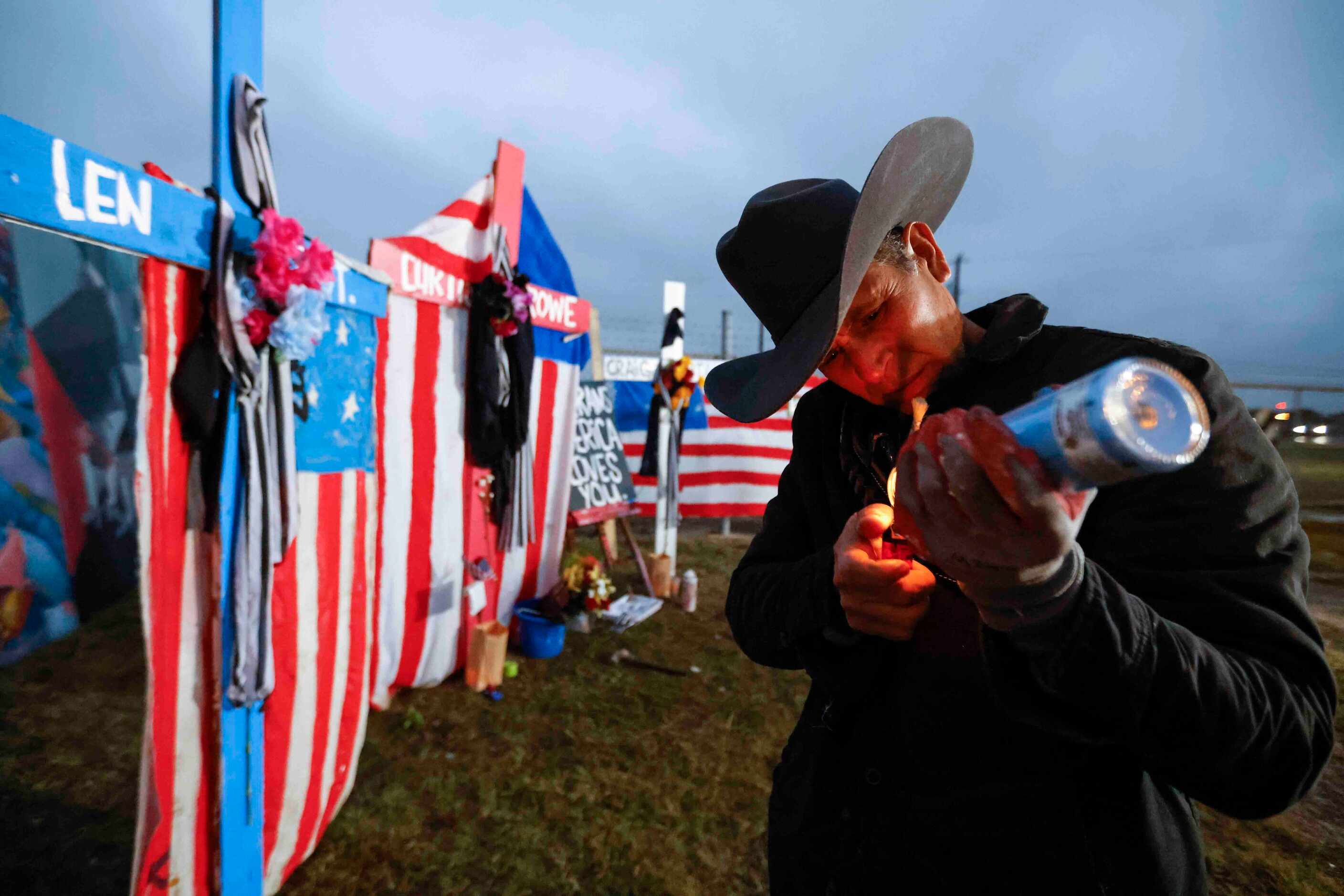 Mural artist Roberto Márquez lights up a candle intended to put on one of the six painted...