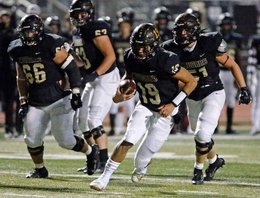 The Colony High School quarterback Jonathan Roberson (19) runs for yardage during the first...