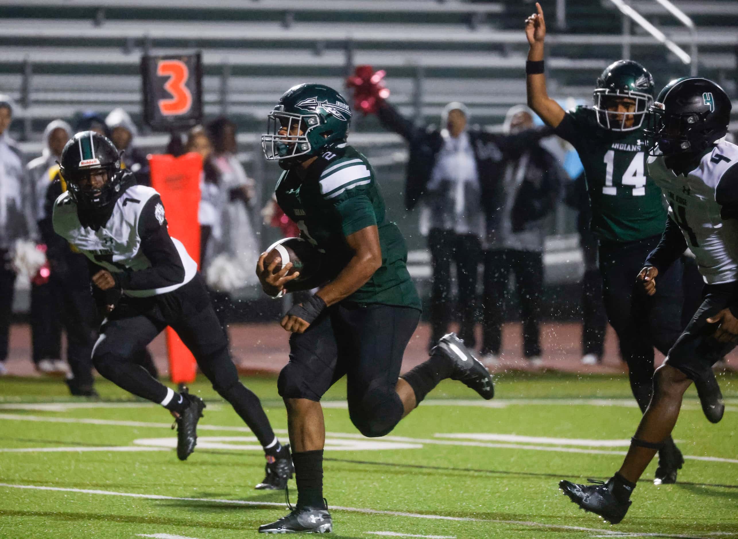 Waxahachie’s Iverson Young (2) runs to the end zone against Mansfield Lake Ridge High during...