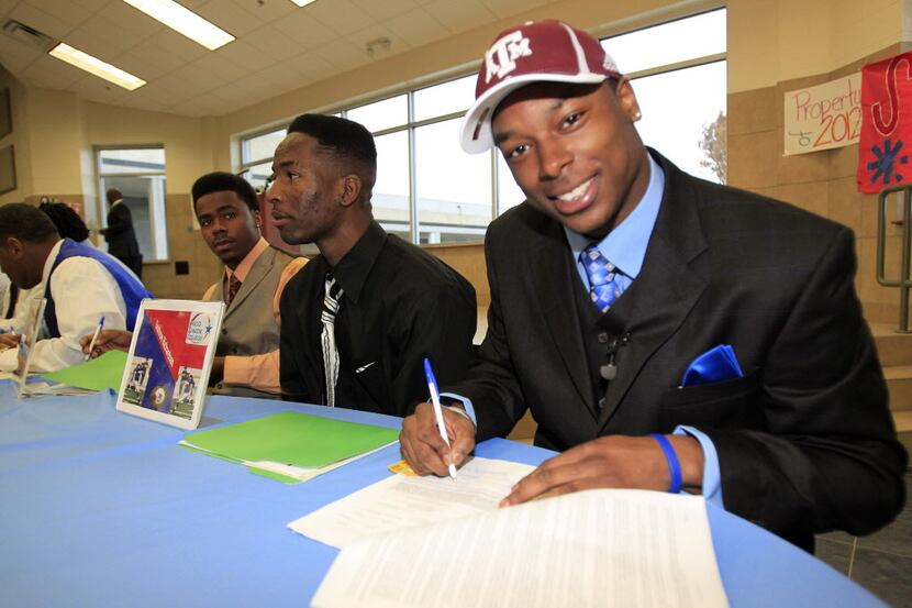 Skyline High wide receiver Thomas Johnson signs his National Letter of Intent to play...