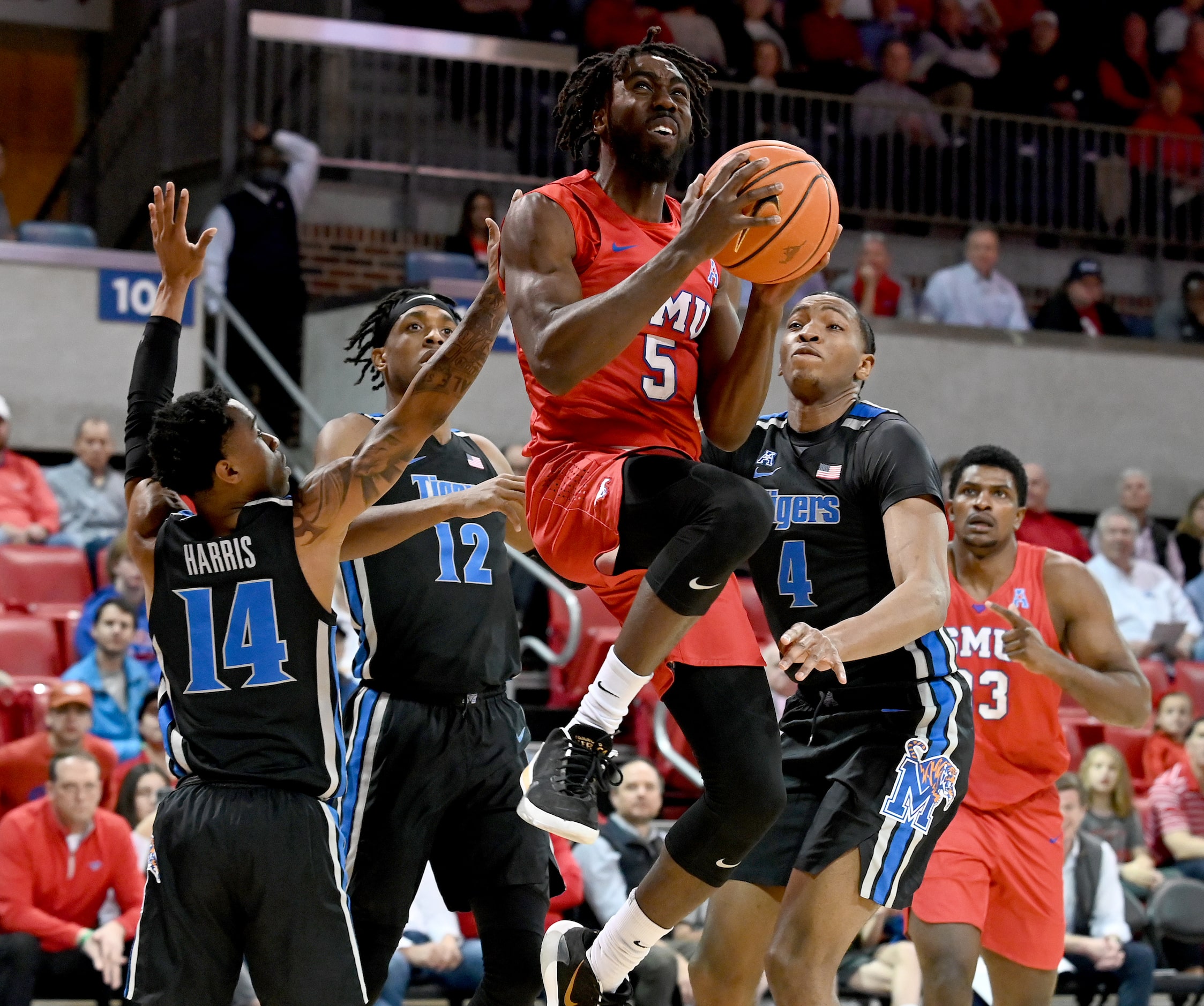 SMU guard Emmanuel Bandoumel (5) drives to the basket between Memphis guard Tyler Harris...