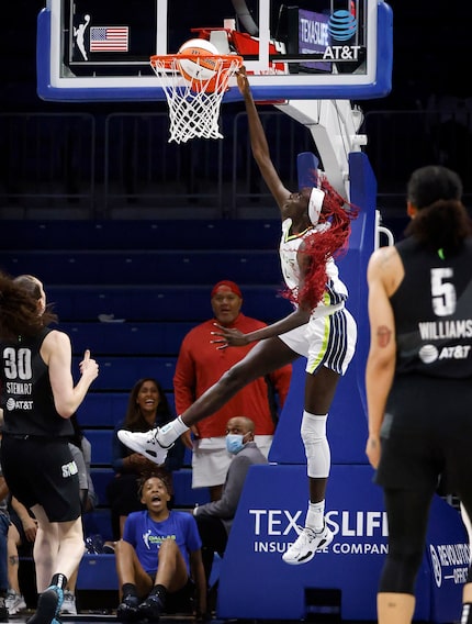 Dallas Wings center Awak Kuier (28) dunks the ball on the Seattle Storm defense during the...