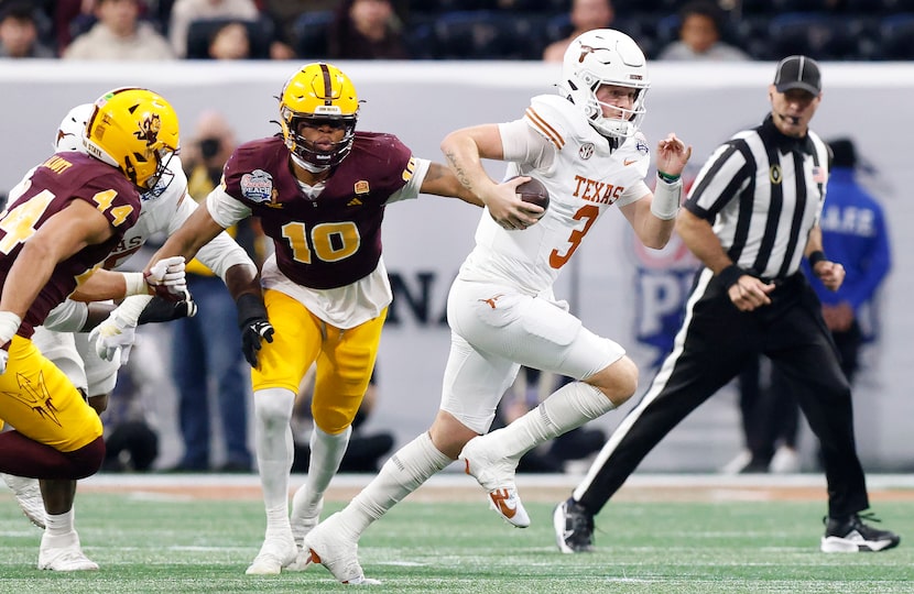 Texas Longhorns quarterback Quinn Ewers (3) takes off running against the Arizona State Sun...