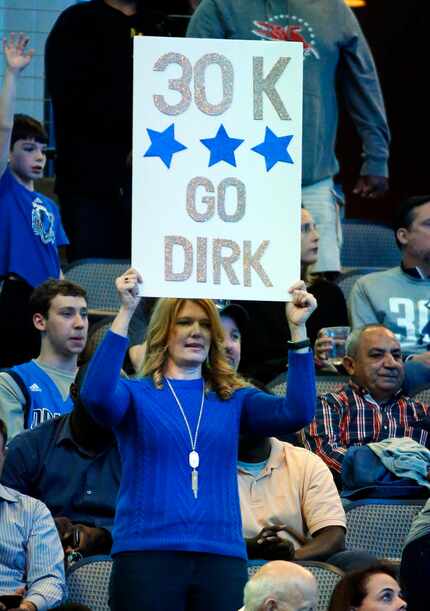 A Dallas Mavericks fan displays a sign following Dirk Nowitzki's 30,000 point accomplishment...