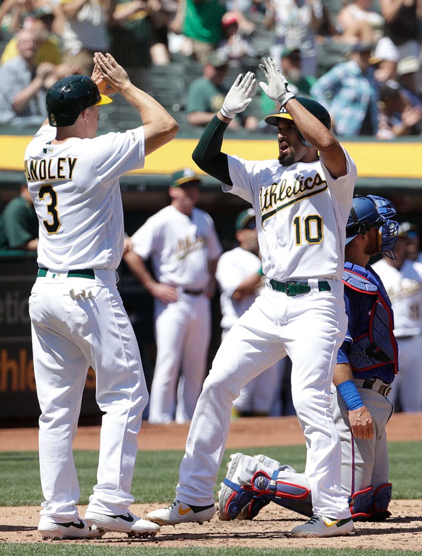 Oakland Athletics' Marcus Semien, right, is congratulated by Nick Hundley (3) after hitting...