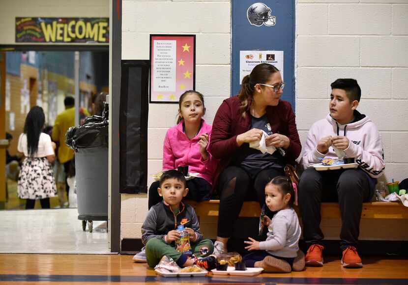 Alma Ruiz, center, and her two oldest children Samantha, left, and Octavio, right, discuss...