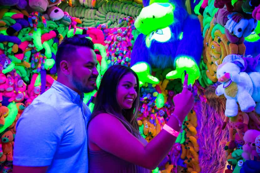 Karen Nino takes a selfie with Brian Rosas at the Sweet Tooth Hotel art installation in July