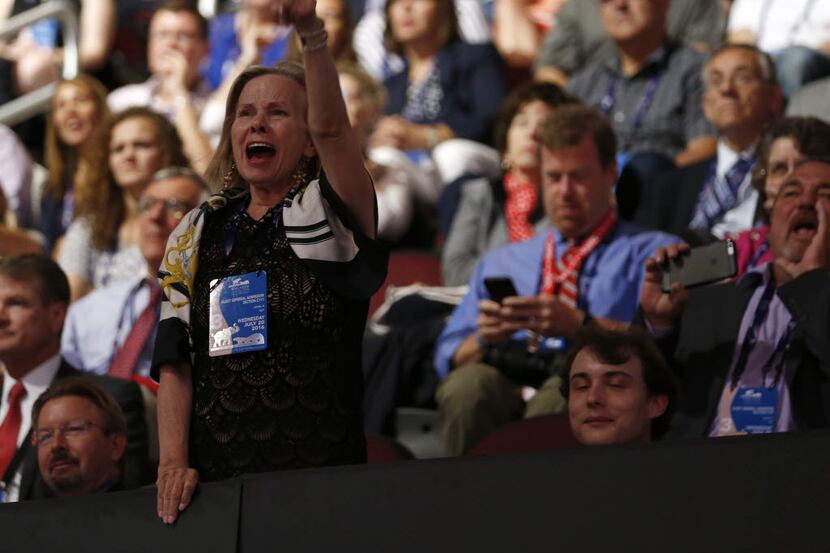 A woman yells for Ted Cruz to say he's backing Donald Trump during his speech at the...