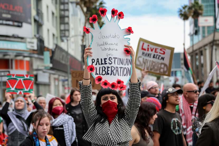 A protester holds a poster during a demonstration in support of Palestinians calling for a...