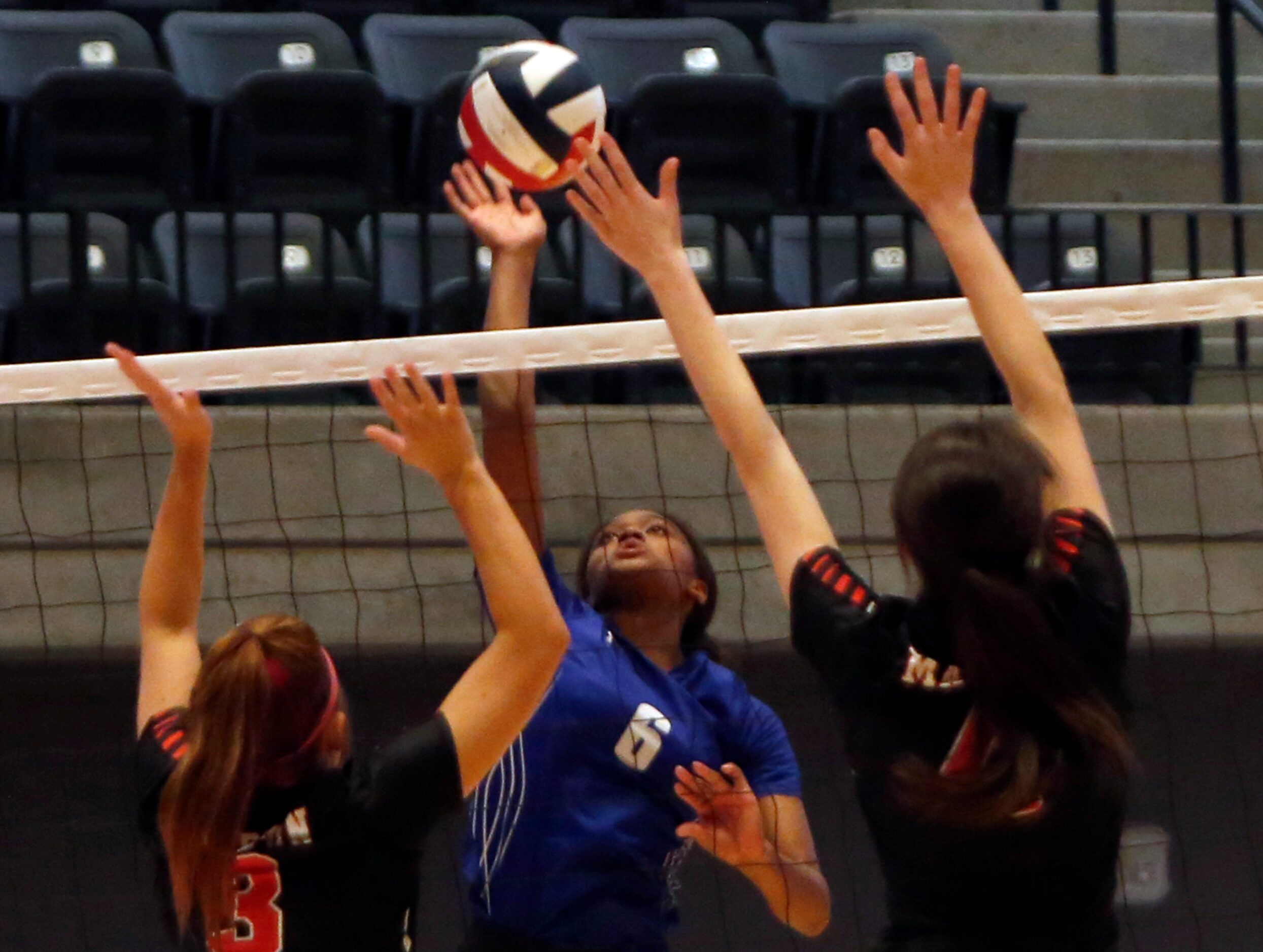 Denton Guyer outside hitter London Hunt (6) delivers a shot between Arlington Martin...