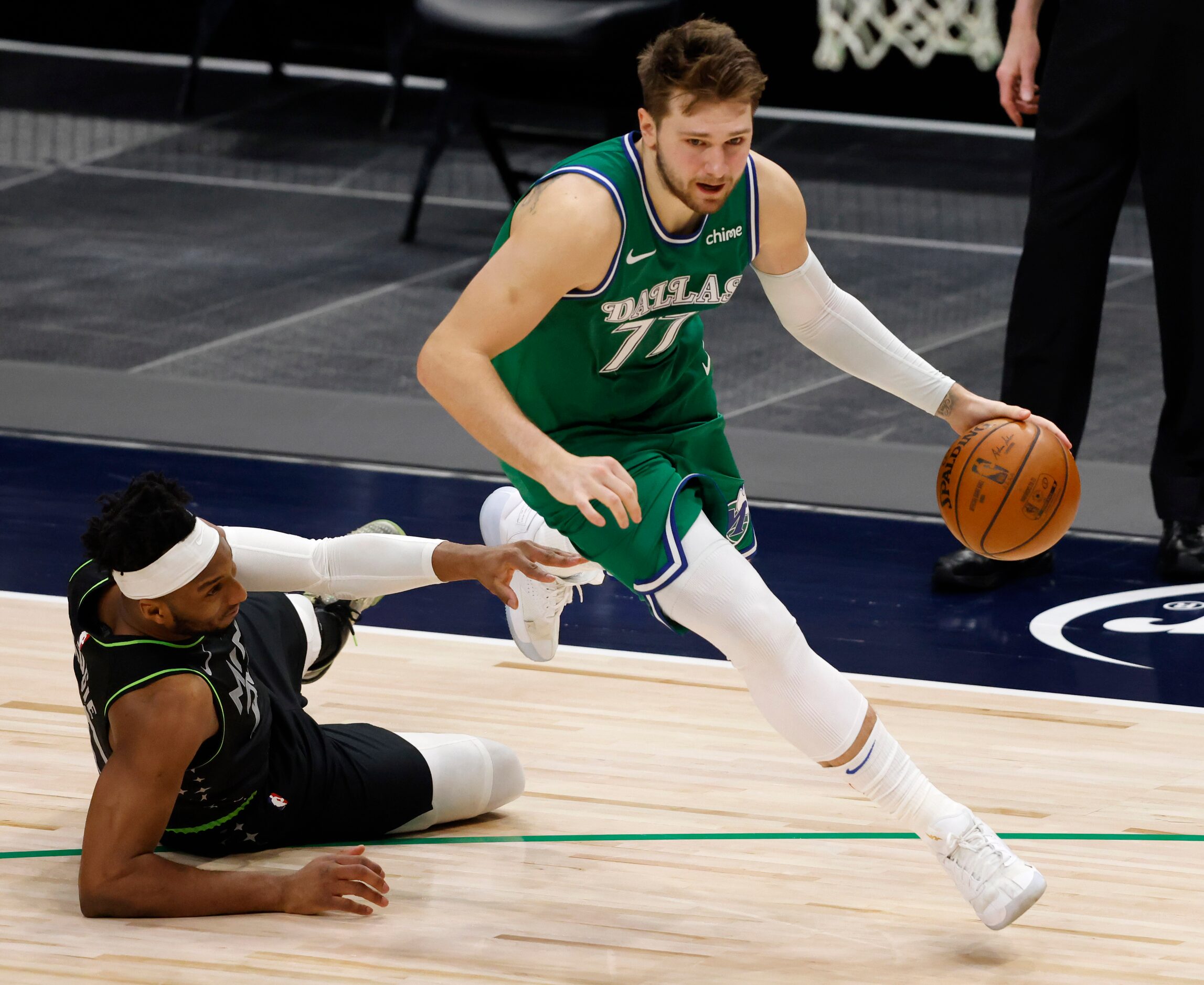 Dallas Mavericks guard Luka Doncic (77) passes by Minnesota Timberwolves forward Josh Okogie...