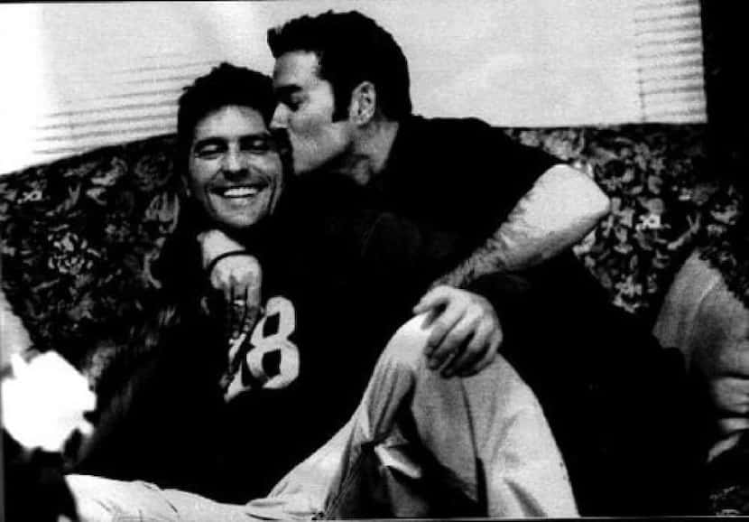 British pop superstar George Michael (right) kisses his Dallas partner Kenny Goss in an...