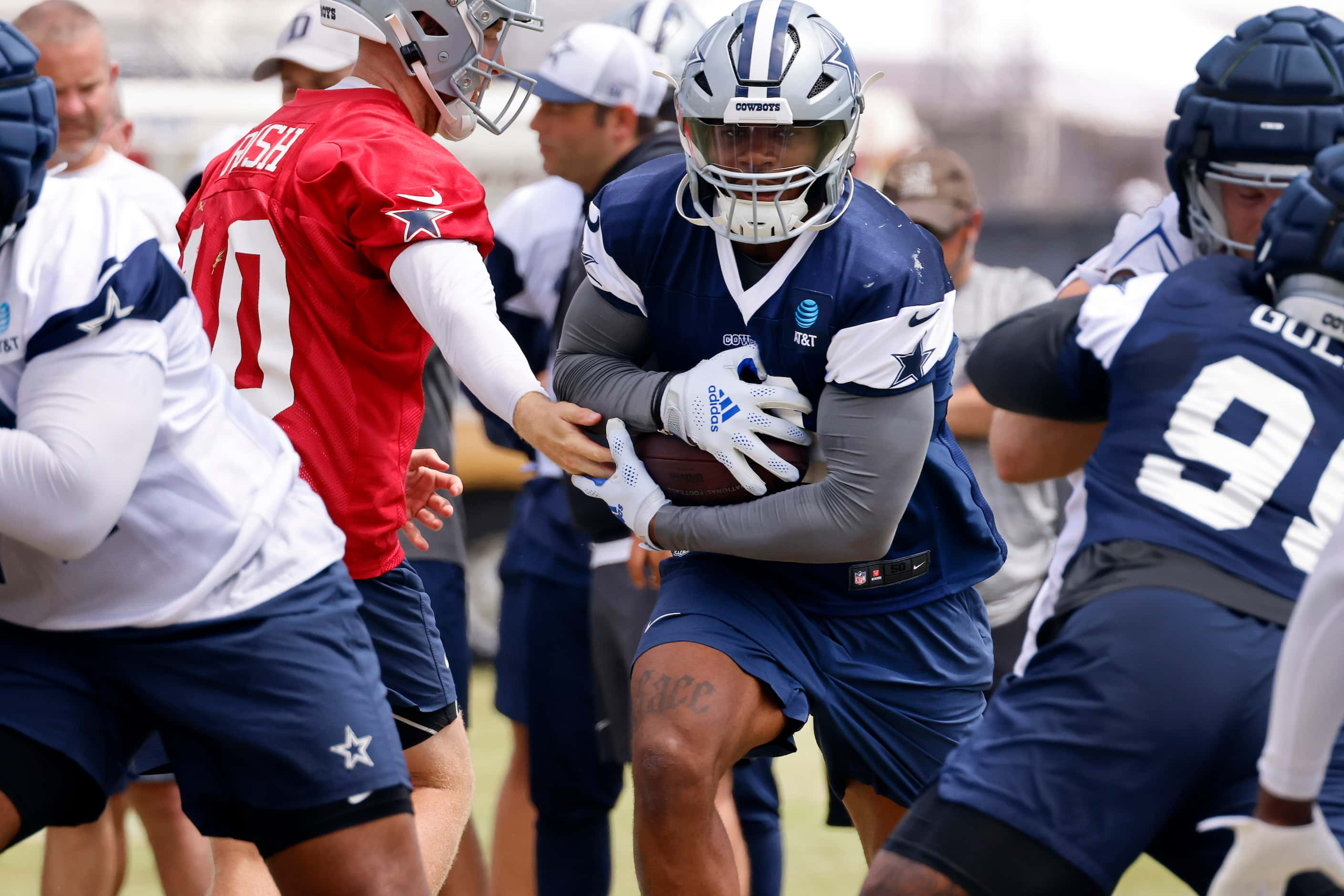 Dallas Cowboys linebacker Micah Parsons (11) takes the handoff from quarterback Cooper Rush...