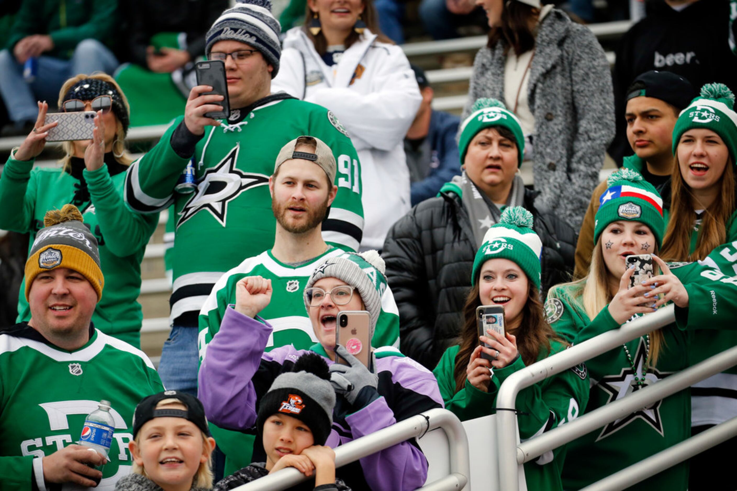 Dallas Stars cheer as the players enter the tunnel before their outdoor NHL Winter Classic...
