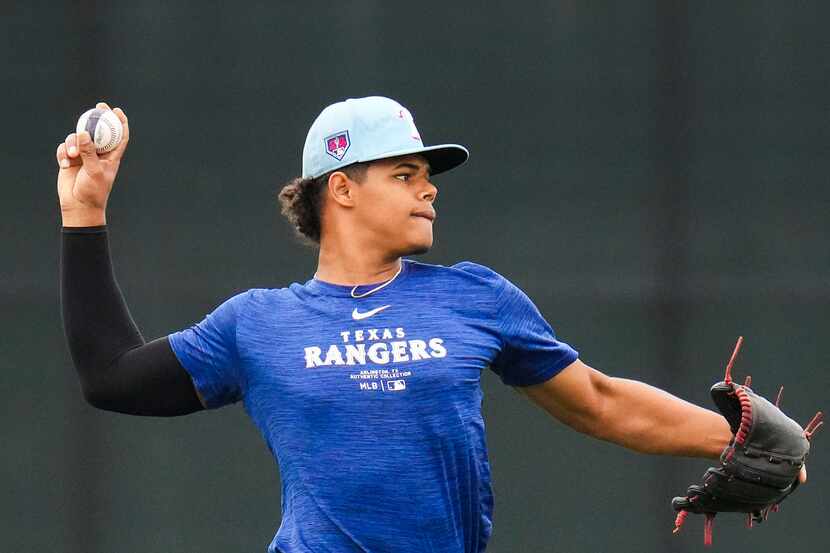 Texas Rangers minor league pitcher Winston Santos participates in a spring training workout...