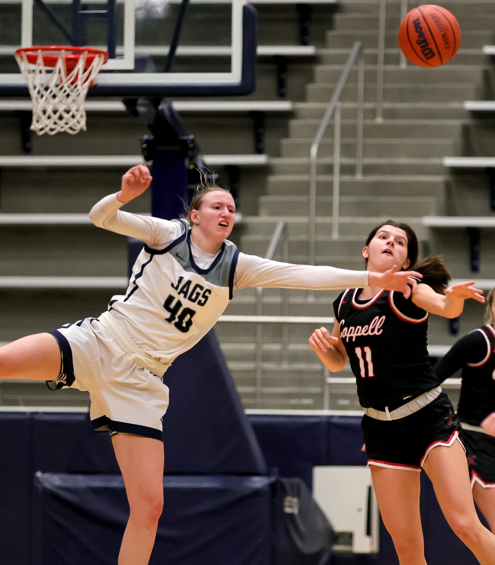 Flower Mound guard Madison Cox (40) and Coppell guard Waverly Hassman (11) go for a loose...