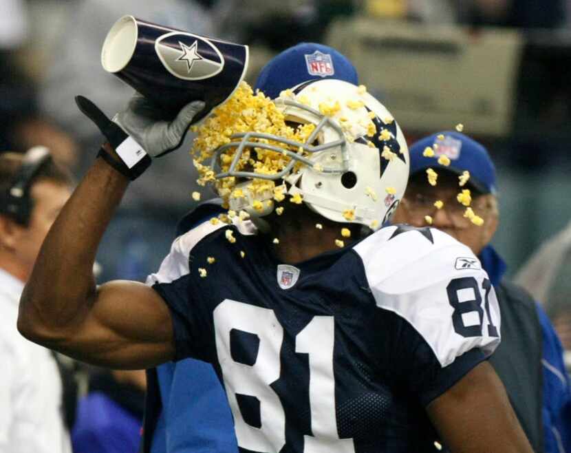 Dallas Cowboys wide receiver Terrell Owens (81) throws popcorn in his face after scoring in...