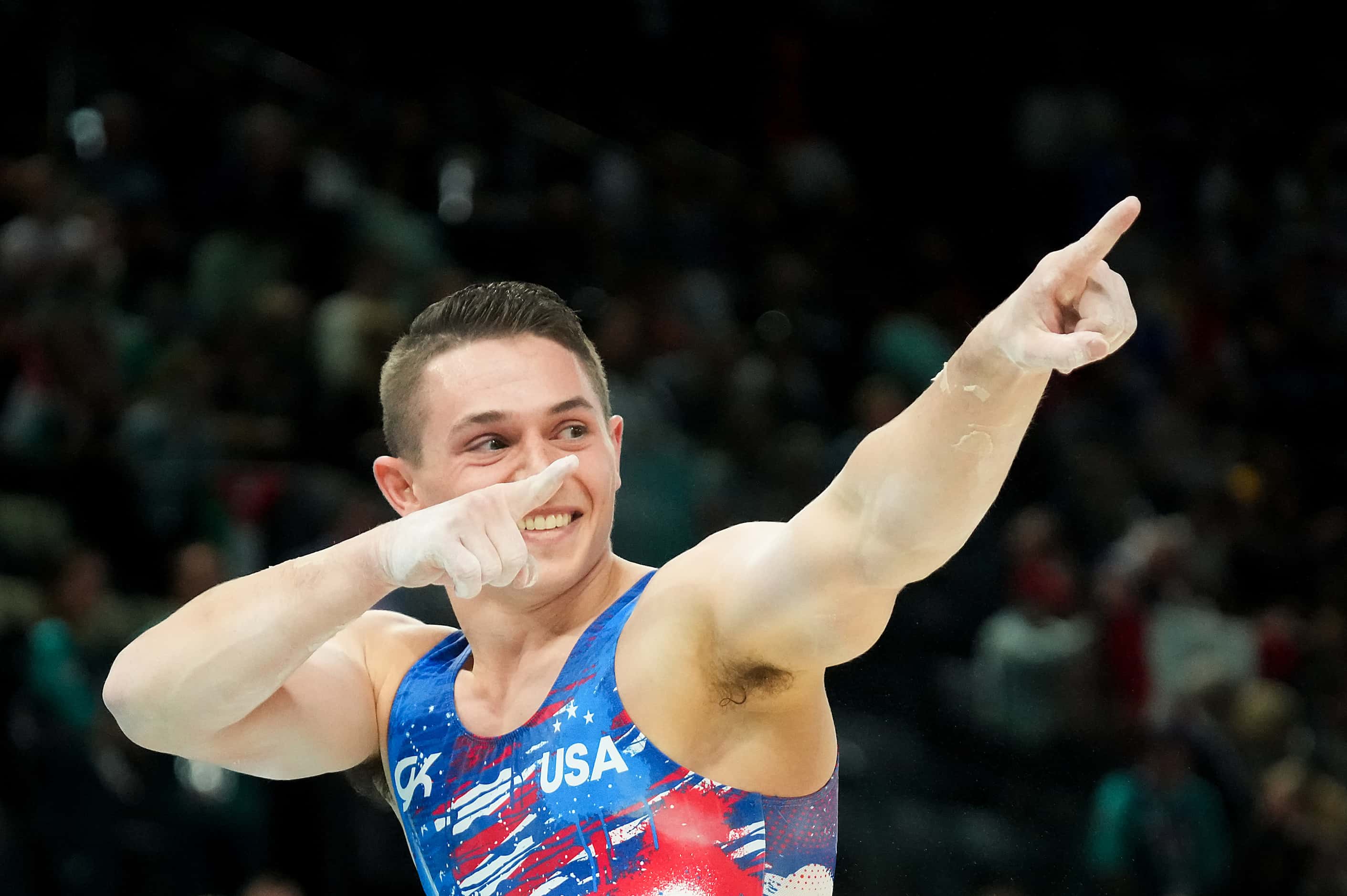 Paul Juda of the United States reacts after competing on the parallel bars during men’s...