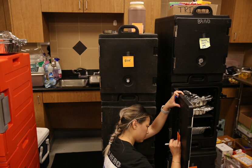 Dory Fung labels dishes at the Houston Police Officers' Union. As officers work...