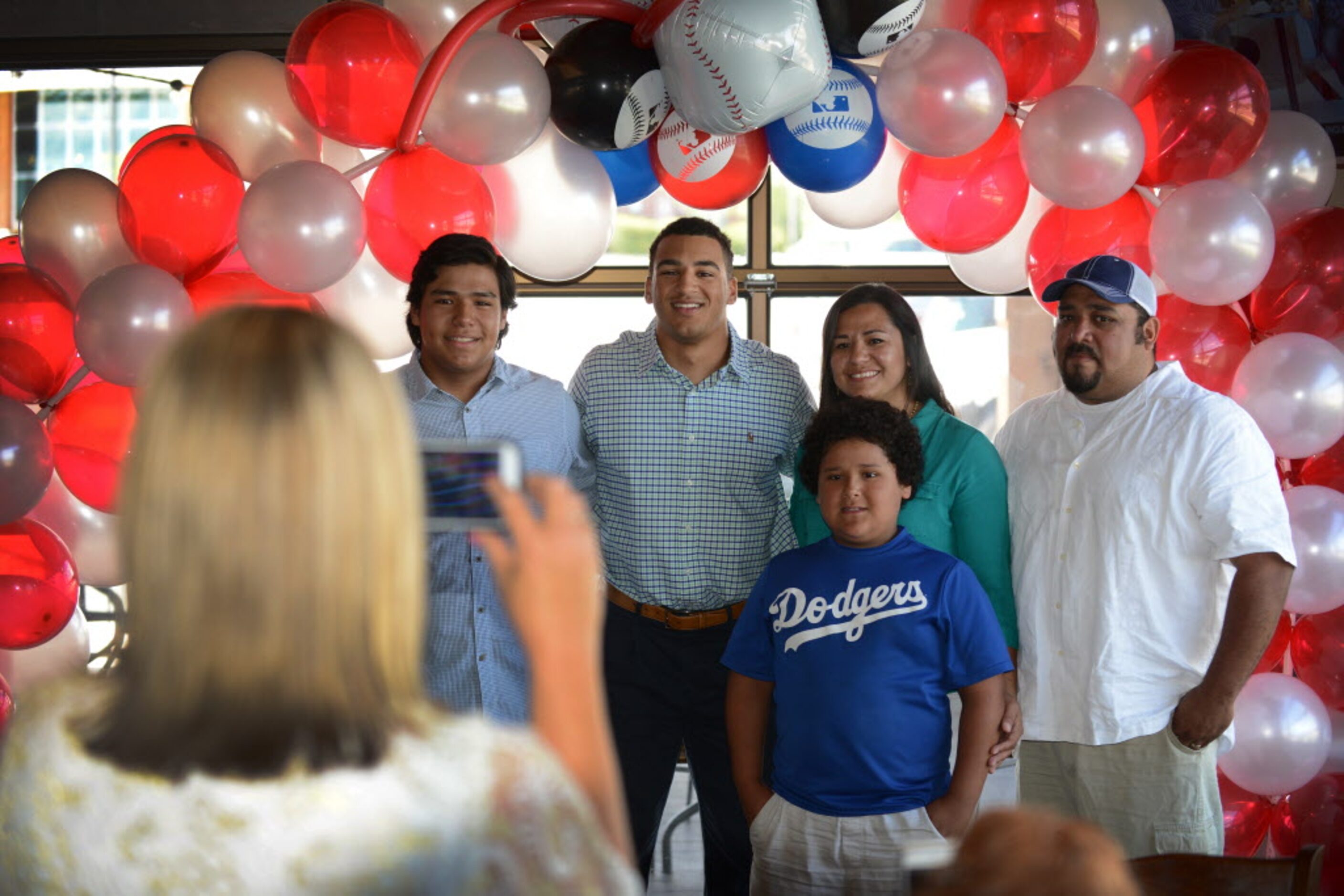 Michelle Grisham, Trent Clarks mother, takes a photo of Trent and friends at a watch party...