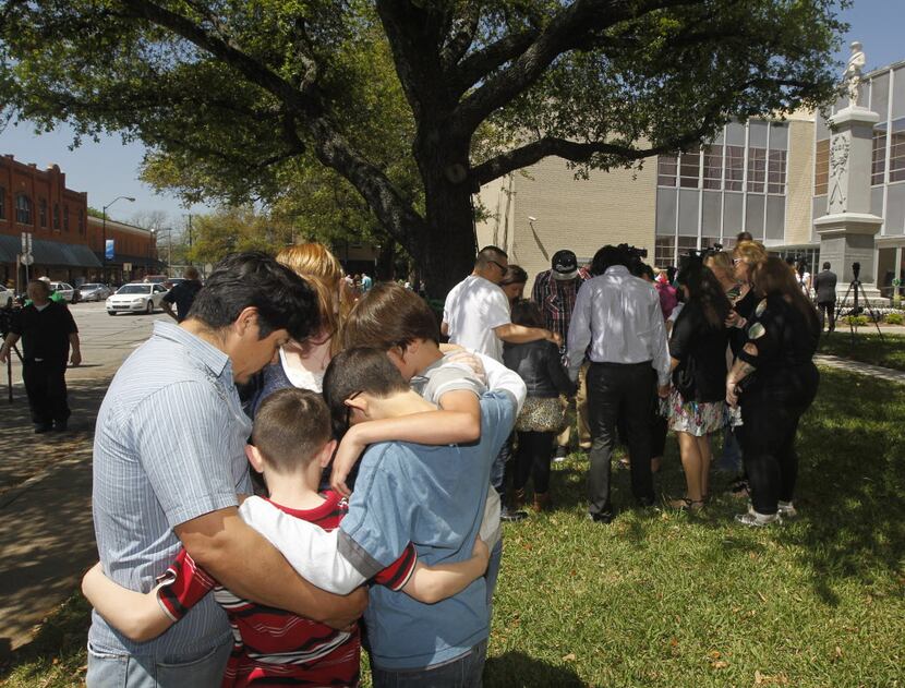 Families pray during a prayer walk around the Kaufman County Courthouse in Kaufman, Texas on...