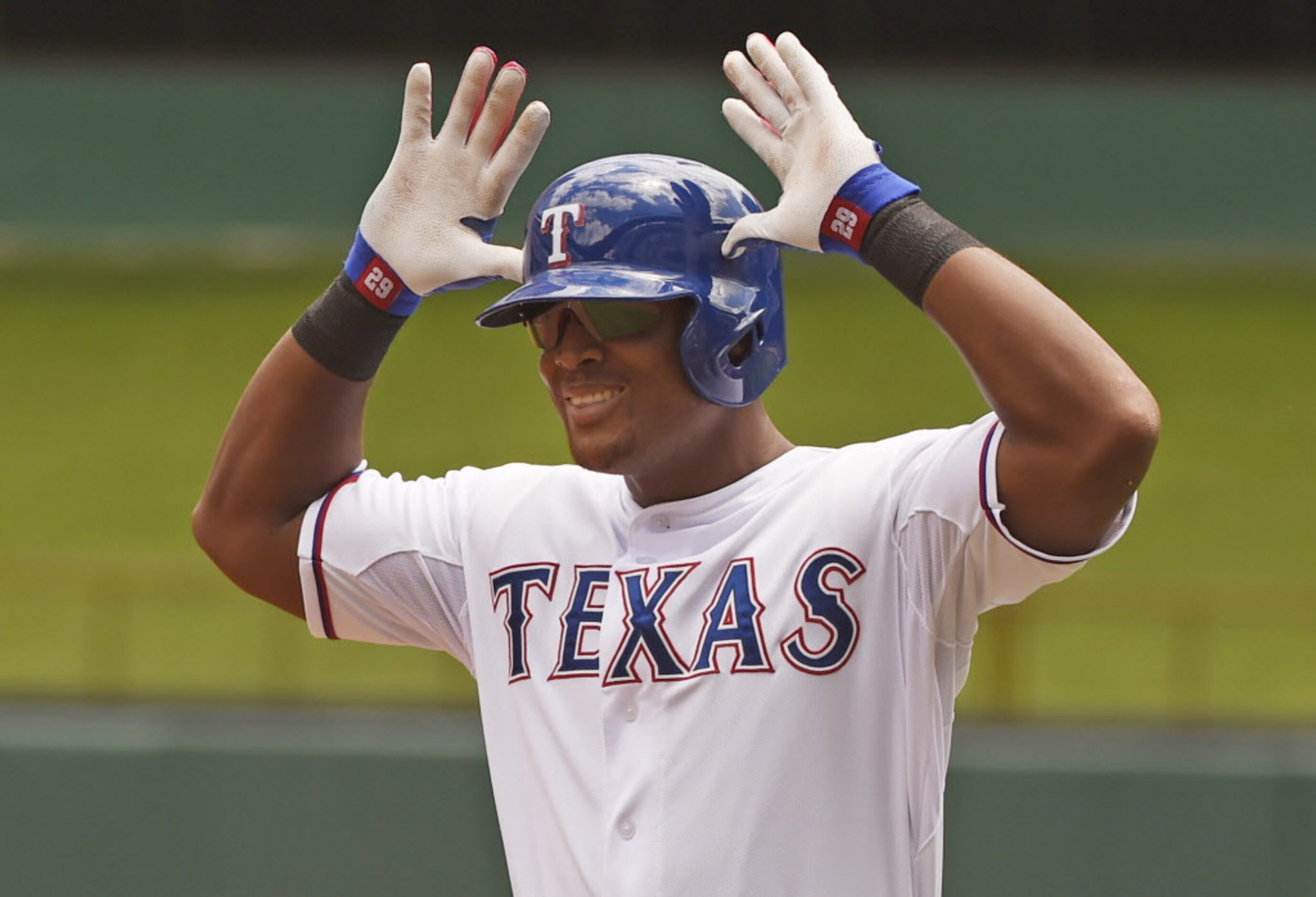 Texas Rangers third baseman Adrian Beltre (29) flashes the antlers sign after he beat out a...